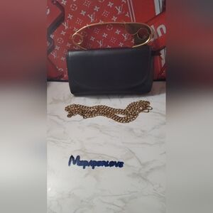 Black Clutch With A Gold Pin